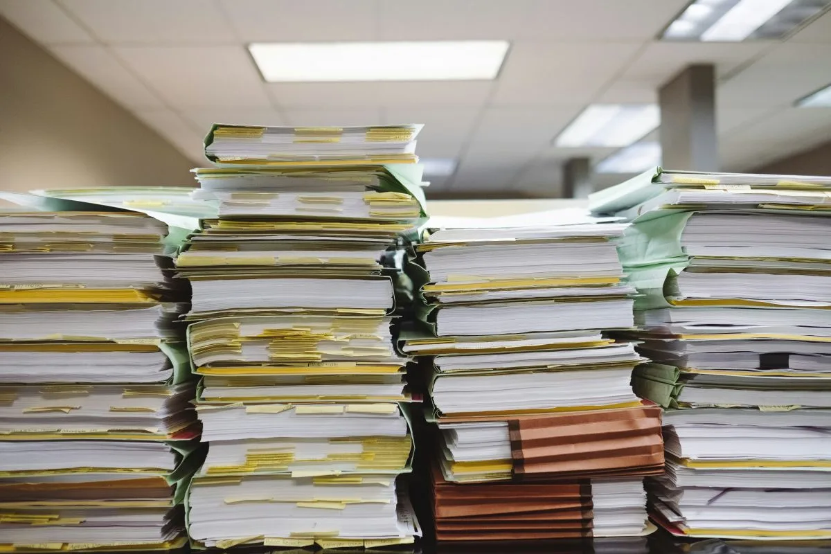 DocAI image of stacks of paper that represent financial auditing work in the logistics industry.